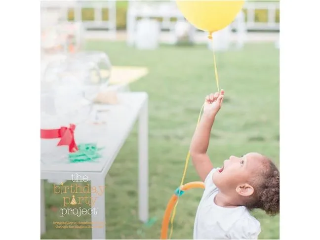 girl holding yellow balloon