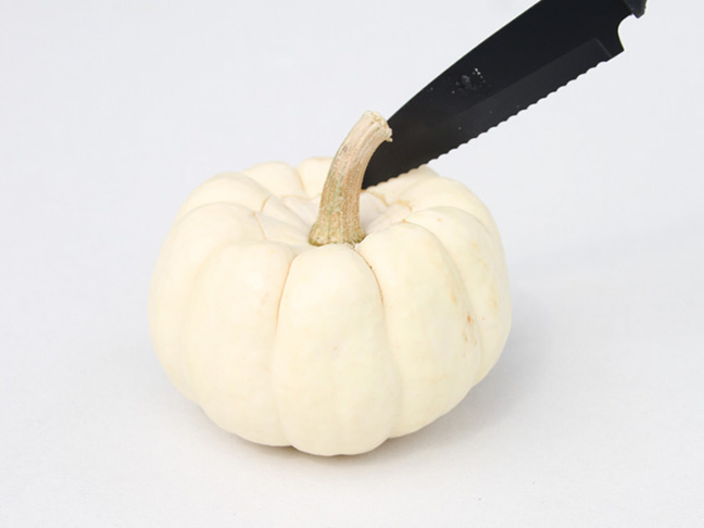 Cut top of pumpkin with knife