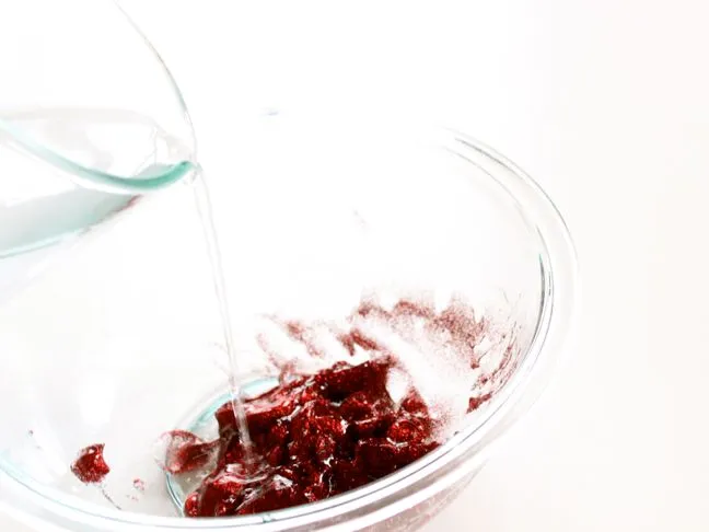 pouring-water-into-a-bowl-with-red-glue