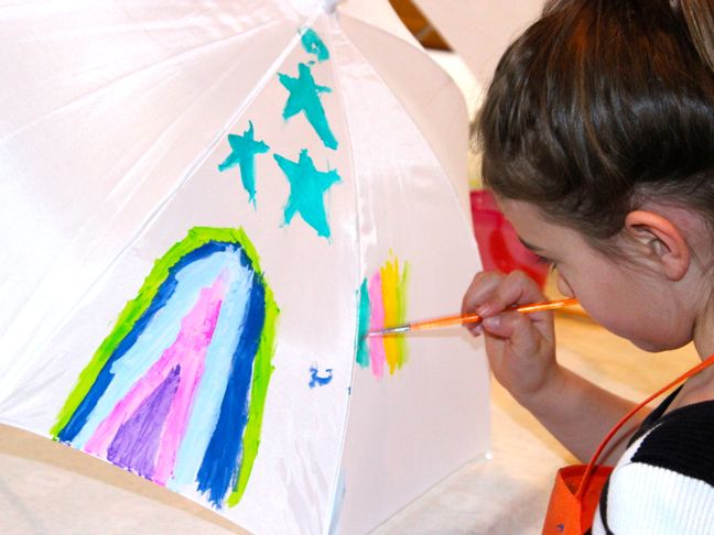 child painting umbrella