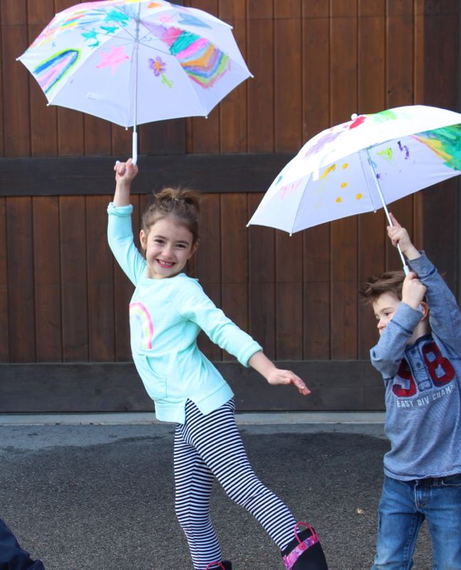 kids holding painted umbrellas