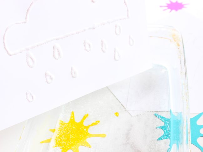 white-salt-rain-drops-on-white-paper-with-yellow-and-blue-paint-splatter