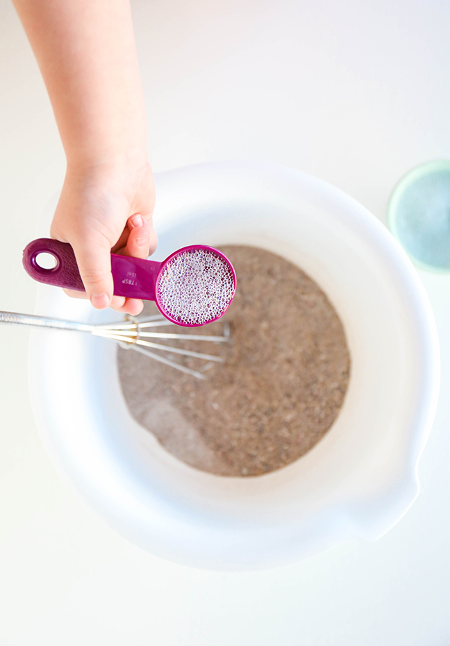 adding soap water to the sand mixture