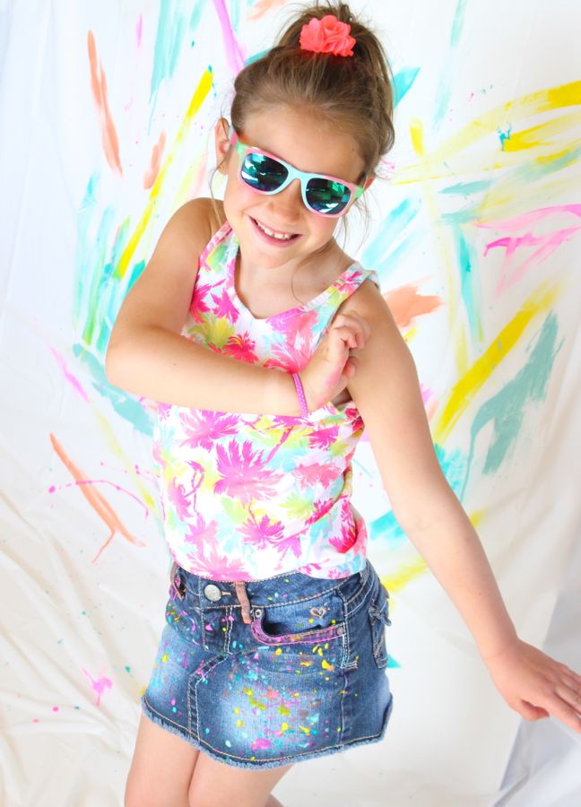 girl-wearing-a-bright-palm-tree-shirt-sunglasses-and-diy-paint-splatter-jeans