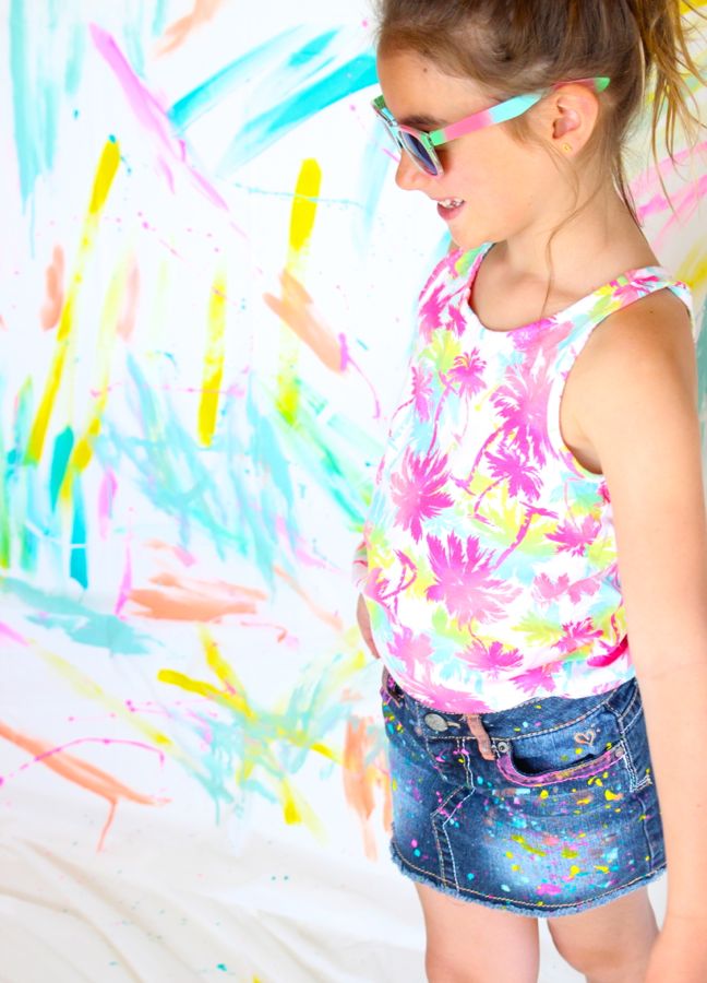 girl-wearing-a-bright-palm-tree-shirt-sunglasses-and-diy-paint-splatter-jeans