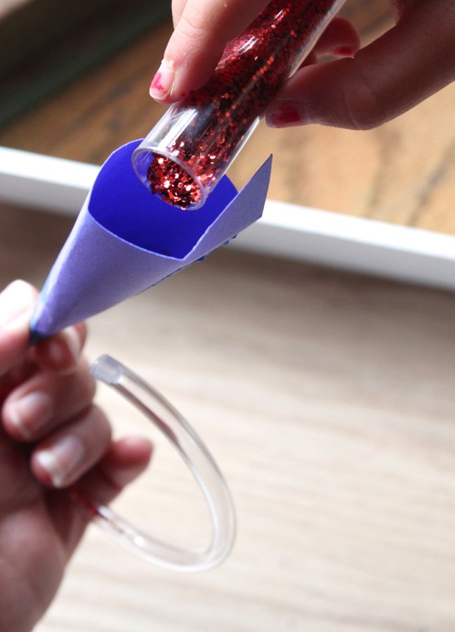 pouring red glitter into funnel