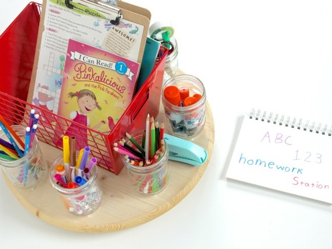 DIY-turntable-homework-station-with-school-supplies-markers-stapler-red-metal-basket-on-a-round-wooden-table
