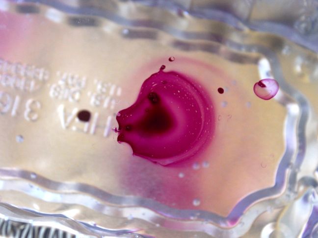 swirling purple nail polish in water