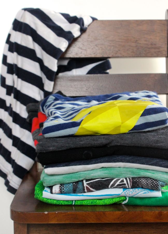 pile-of-t-shirts-stacked-on-a-chair
