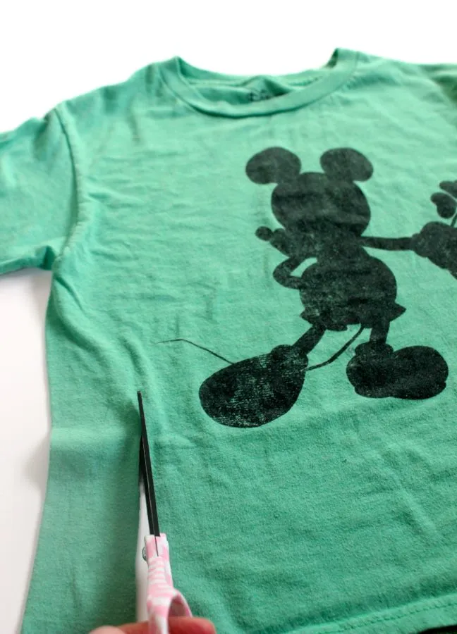 cutting-a-green-mickey-shirt-with-scissors