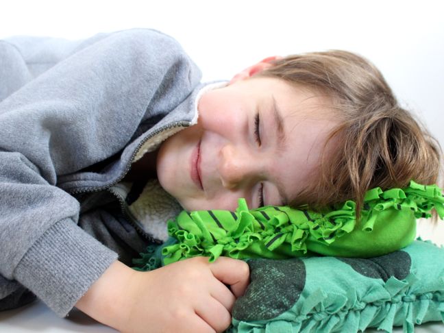 boy-sleeping-on-diy-green-pillows