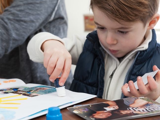 boy-scrapbooking-with-a-glue-stick