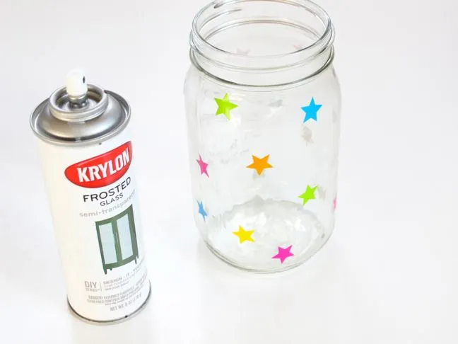 colorful-stars-on-a-mason-jar-next-to-a-can-of-frosted-glass-spray-paint