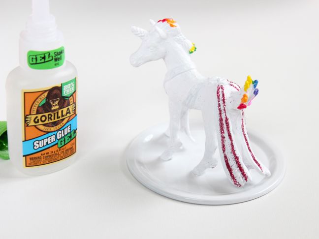 white-toy-unicorn-with-rainbow-color-highlights-glued-to-a-mason-jar-lid-gorilla-glue