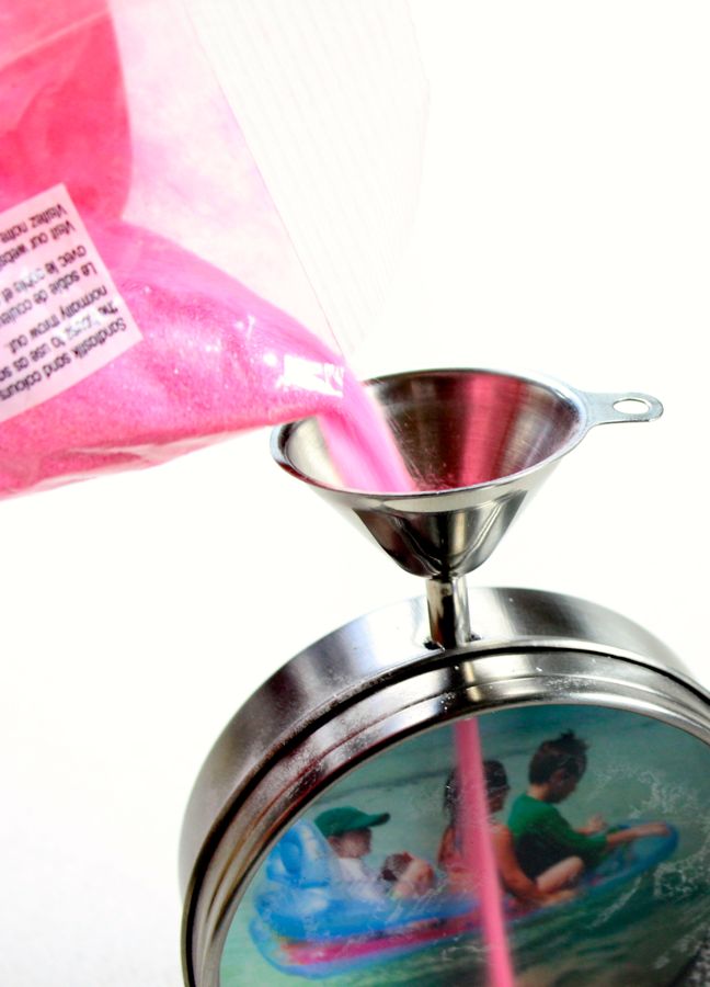 pouring-pink-sand-into-a-metal-funnel-for-a-diy-sand-art-frame