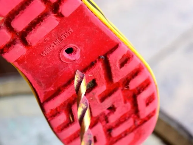 drill-a-hole-in-the-bottom-of-a-shoe-with-a-red-sole