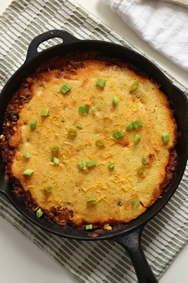 Tamale pie is classic American comfort food. It has a chili-like filling with cornbread baked right over the top. The bonus is that it's all made in one skillet making clean-up super easy! 