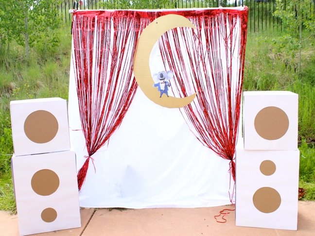sing-stage-for-kids-with-cardboard-speakers-and-a-red-metallic-curtain-outdoor-mini-diy-stage