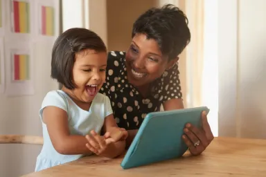 mom showing child earth rangers app on tablet