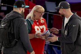 Mother Donna Kelce (C) gives cookies to her son's Jason Kelce (L) #62 of the Philadelphia Eagles and Travis Kelce (R) #87 of the Kansas City Chiefs during Super Bowl LVII Opening Night presented by Fast Twitch at Footprint Center on February 06, 2023 in Phoenix, Arizona.