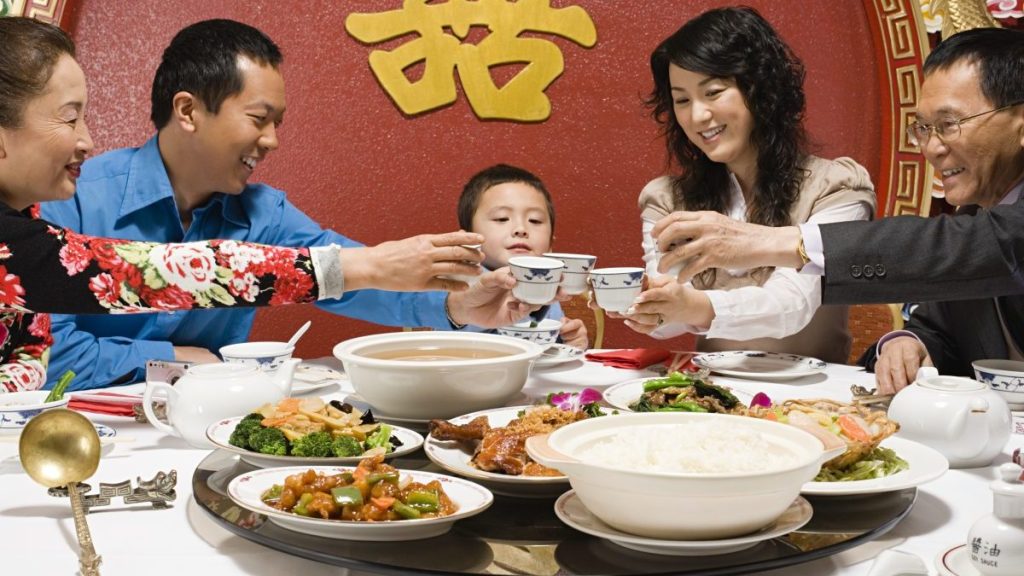 Family toasting at reunion dinner during Chinese New Year