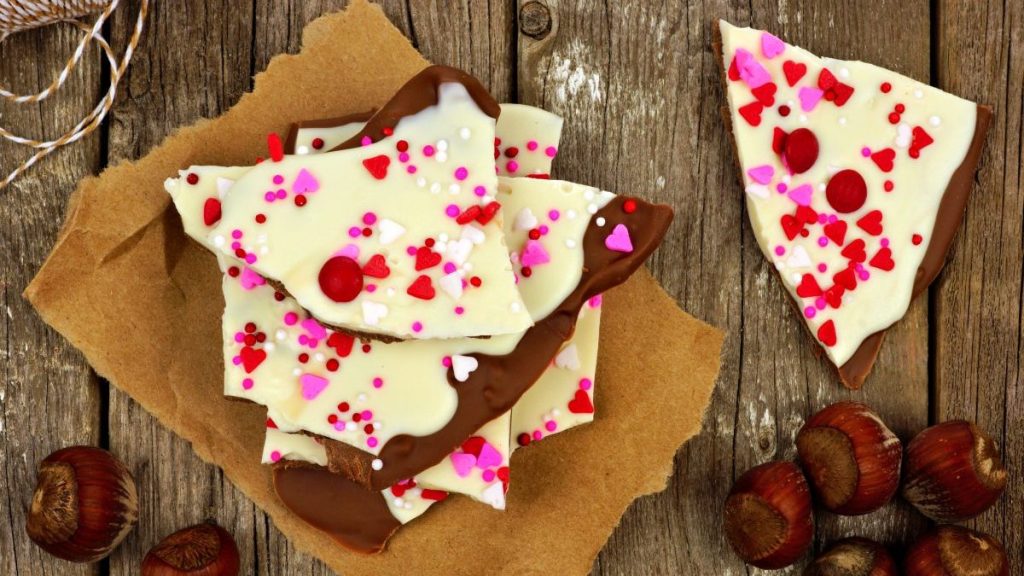 White and dark chocolate bark with almonds and candy heart sprinkles for Valentine's Day