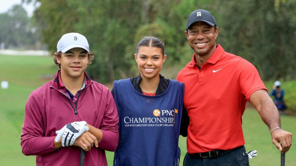 Tiger Woods of The United States poses for a picture on the first tee with his son Charlie Woods and his daughter Sam Woods who was caddying for Tiger during the final round of the PNC Championship at The Ritz-Carlton Golf Club on December 17, 2023 in Orlando, Florida.