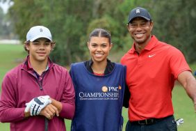 Tiger Woods of The United States poses for a picture on the first tee with his son Charlie Woods and his daughter Sam Woods who was caddying for Tiger during the final round of the PNC Championship at The Ritz-Carlton Golf Club on December 17, 2023 in Orlando, Florida.