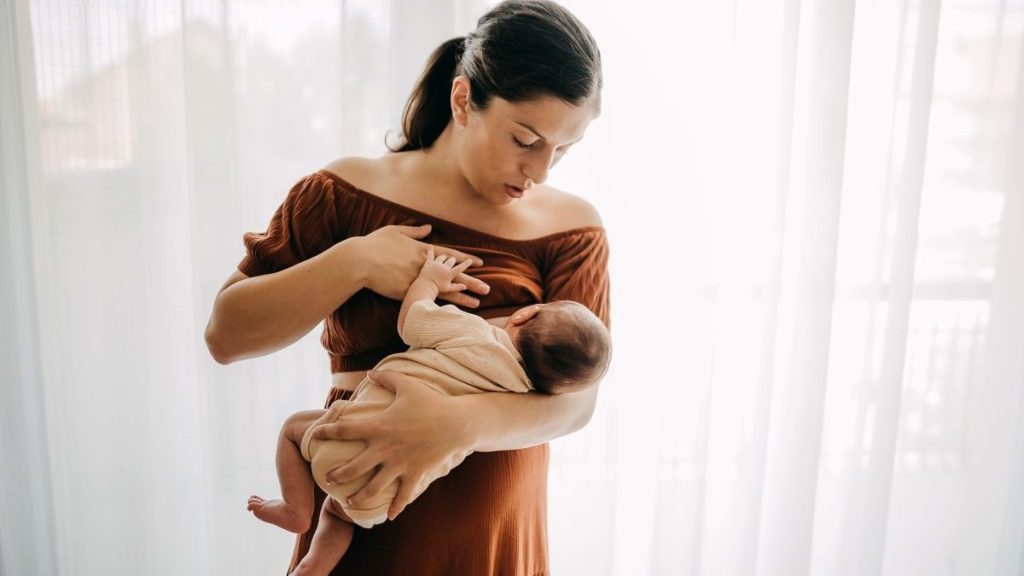 Mother breastfeeding her newborn son