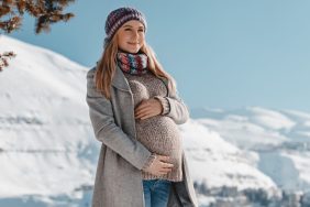 Pregnant Woman in Winter Clothes Touching her Belly