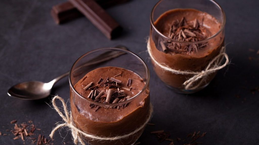 Homemade dark chocolate mousse on black surface