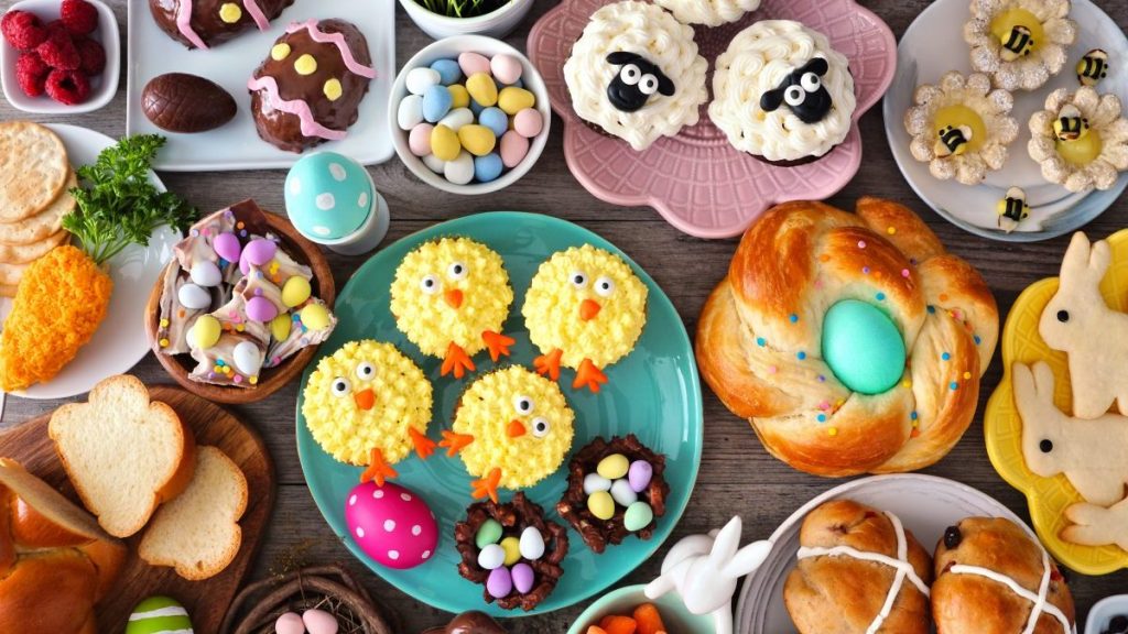 Easter table scene with an assortment of breads, desserts and treats