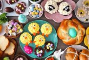 Easter table scene with an assortment of breads, desserts and treats