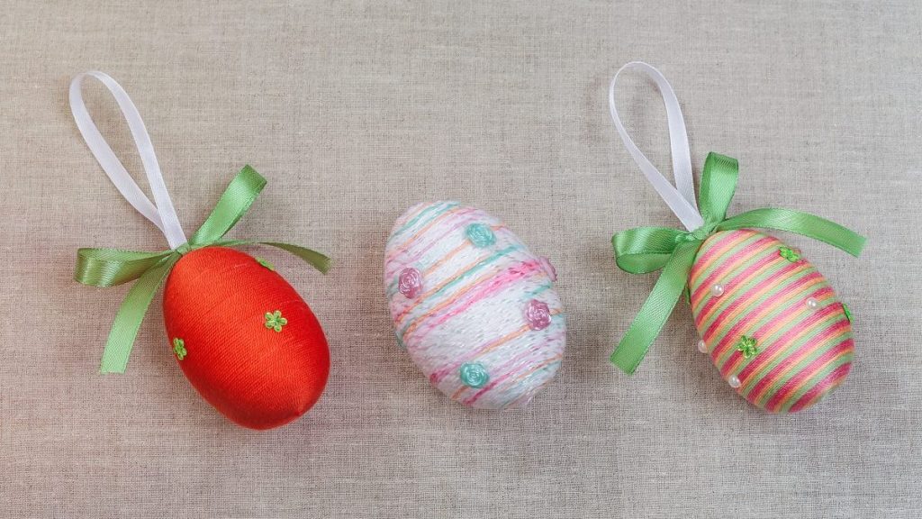 Colorful Easter eggs with ribbon bow on sackcloth background