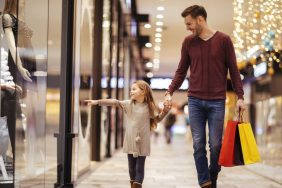 Father and daughter spending a day in shopping mall