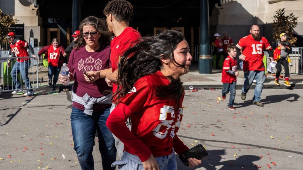 People flee after shots were fired near the Kansas City Chiefs' Super Bowl LVIII victory parade on February 14, 2024, in Kansas City, Missouri. A shooting incident at a packed parade Wednesday to celebrate the Kansas City Chiefs' Super Bowl victory killed one person and injured 21 others, police said.