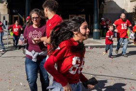 People flee after shots were fired near the Kansas City Chiefs' Super Bowl LVIII victory parade on February 14, 2024, in Kansas City, Missouri. A shooting incident at a packed parade Wednesday to celebrate the Kansas City Chiefs' Super Bowl victory killed one person and injured 21 others, police said.