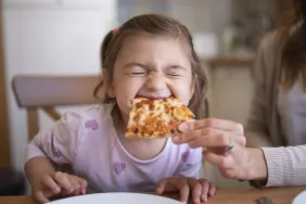 Cute girl eating pizza