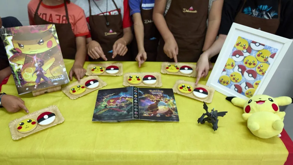 Several children show the Pokemon cookies they have made at a summer camp organized by Obrador Dulcemente, on August 16, 2021, in Madrid, Spain. The children, aged between 7 and 13, make a different sweet preparation each day, which they then take home with them.