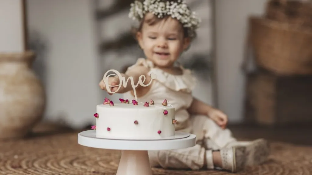Cute girl touching birthday cake