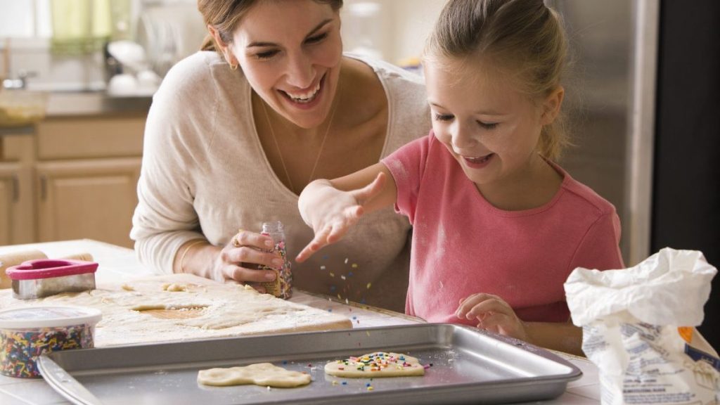 Mother and daughter bonding over decorating Valentine's Day cookies