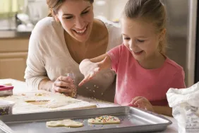 Mother and daughter bonding over decorating Valentine's Day cookies