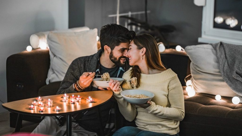 Young couple having a romantic dinner at home on Valentine's Day