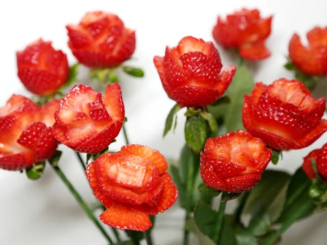 Make edible roses out of strawberries