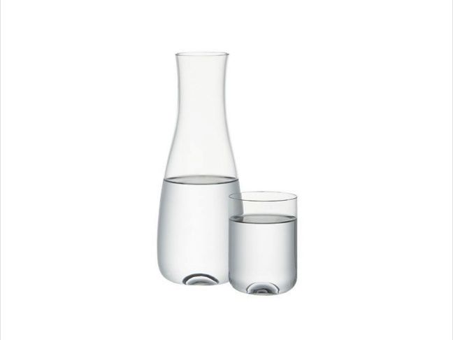 Place a carafe with a glass on the nightstand