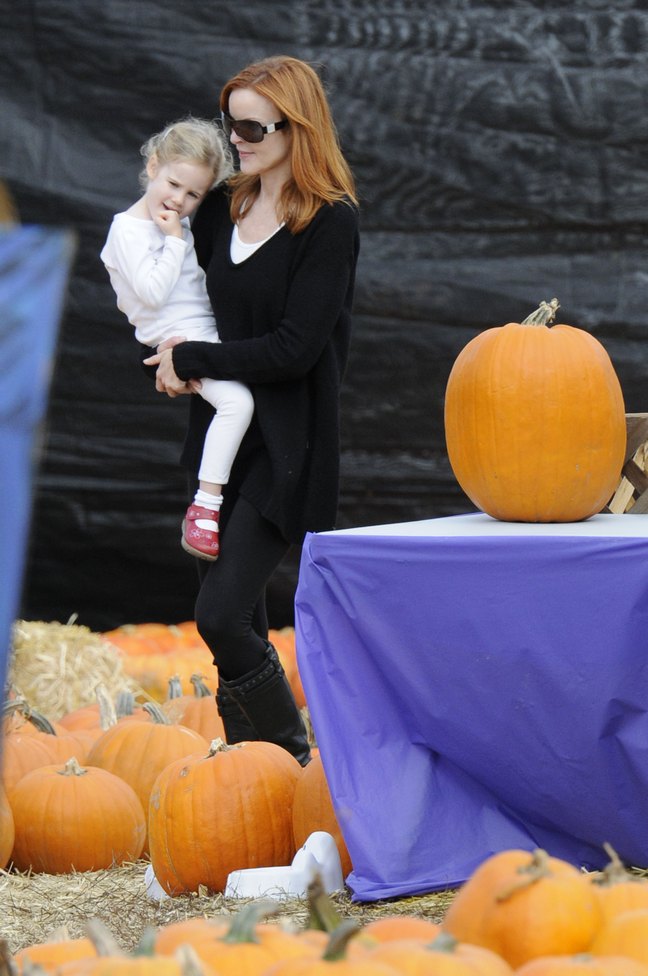 Marcia Cross, black top, black boots, sunglasses